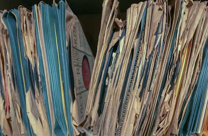 a close up of a bunch of papers on a shelf