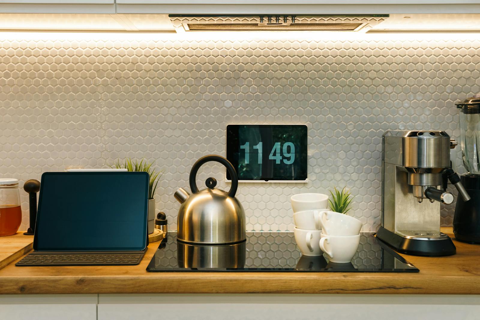 A stylish kitchen with smart devices, coffee machine, and digital clock on counter.