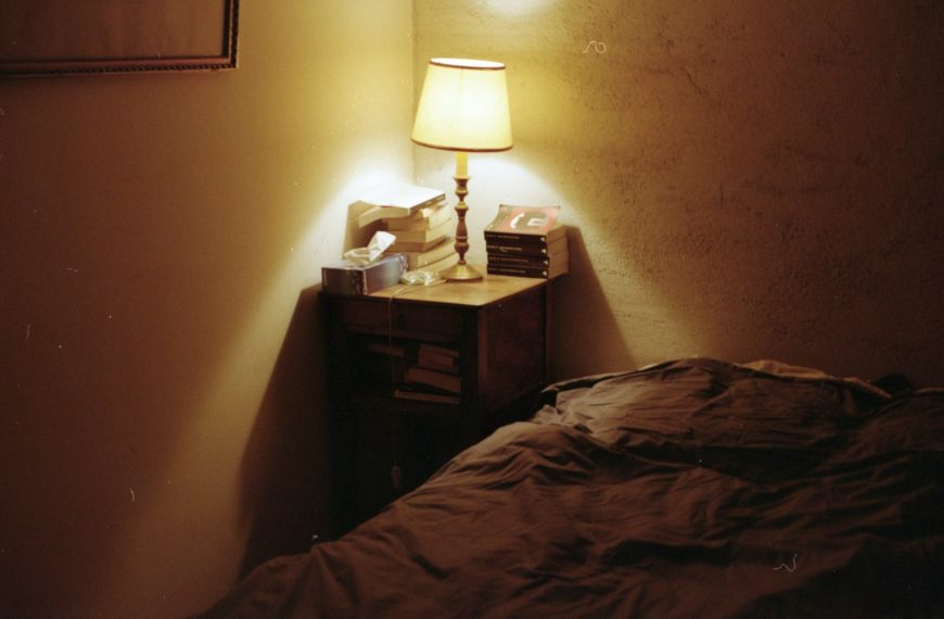 white table lamp on brown wooden nightstand