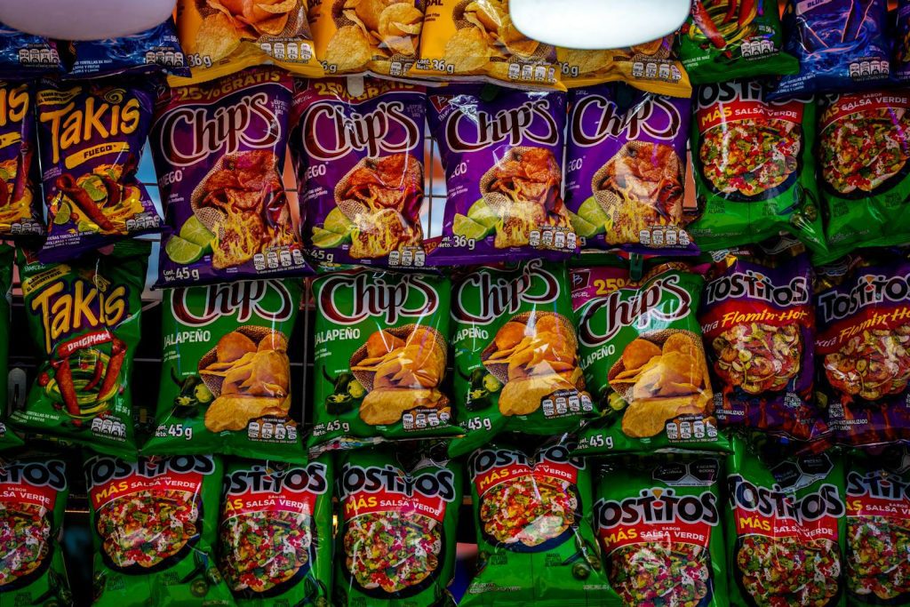 Colorful assortment of snack bags displayed on a shelf, showcasing popular brands and flavors.