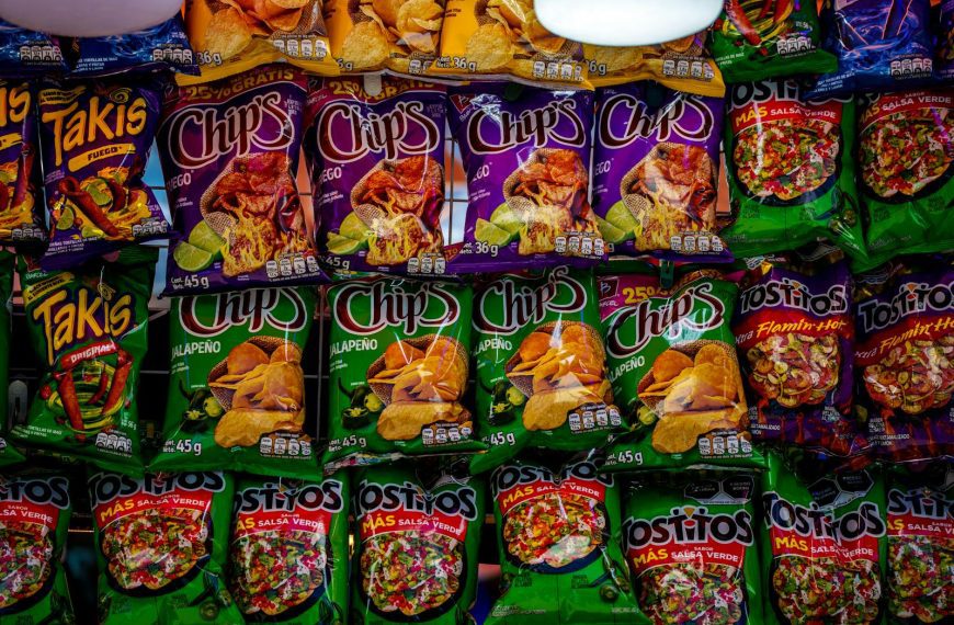Colorful assortment of snack bags displayed on a shelf, showcasing popular brands and flavors.