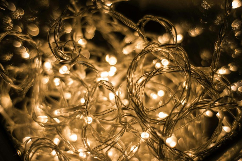 Close-up of tangled golden Christmas lights creating a warm, festive glow.
