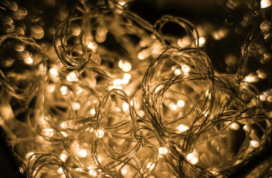 Close-up of tangled golden Christmas lights creating a warm, festive glow.