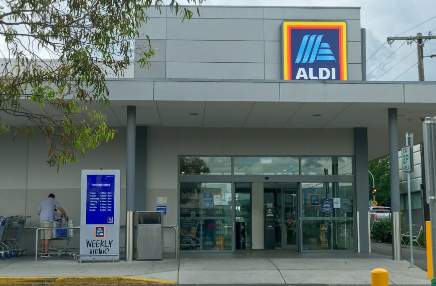 white and blue building near green tree during daytime