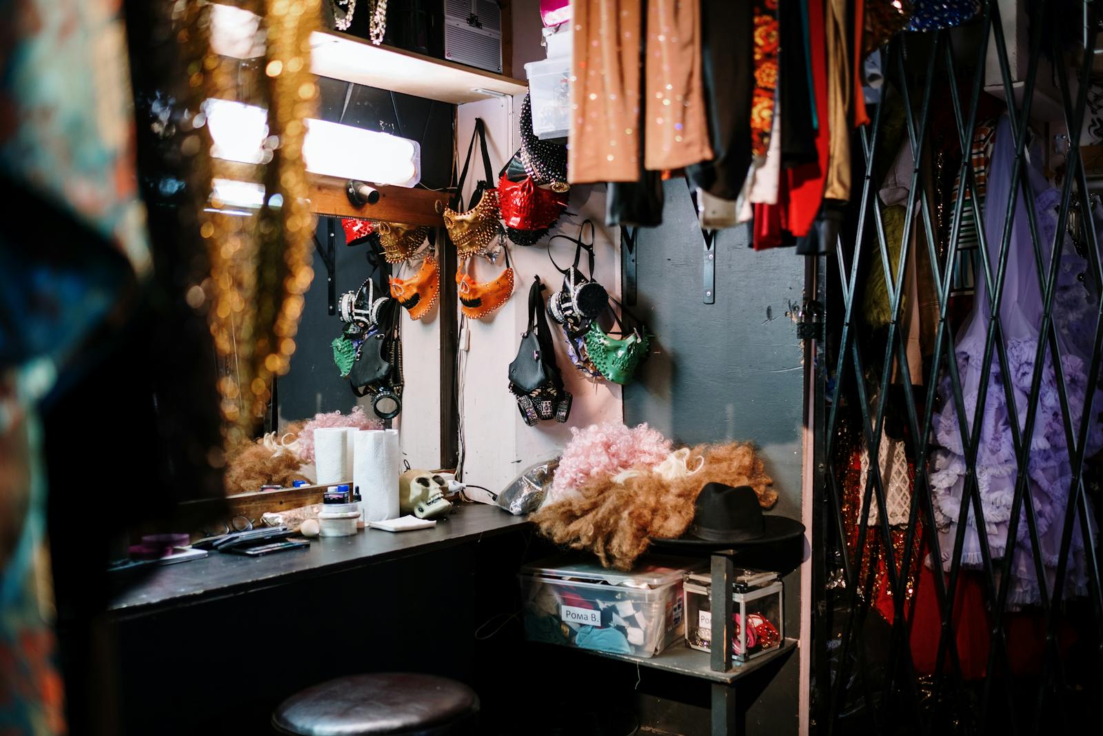 A vibrant dressing room filled with colorful costumes and theatrical accessories.