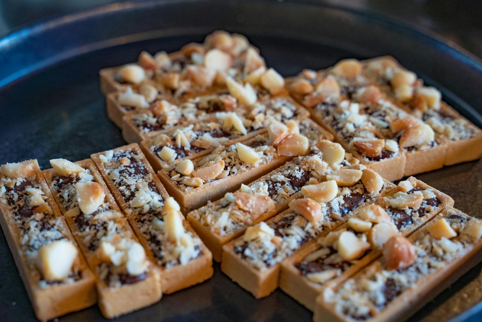 Close-up photo of crunchy nut dessert bars on a baking tray, delicious and appetizing.