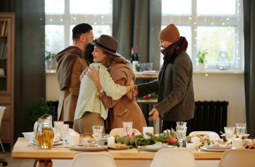 Family embracing and dining together indoors during festive holiday season.