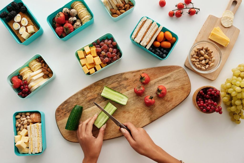 Overhead view of fresh fruit and vegetables being prepared for a healthy lunch.