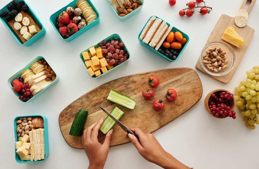Overhead view of fresh fruit and vegetables being prepared for a healthy lunch.