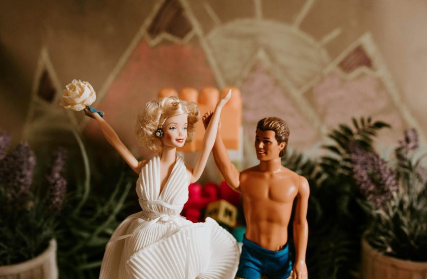 Happy couple of dolls holding hands together and raising up celebrating wedding day in hall decorated with plants