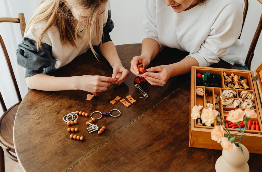 Two women engaging in a creative DIY crafting session on a rustic wooden table.