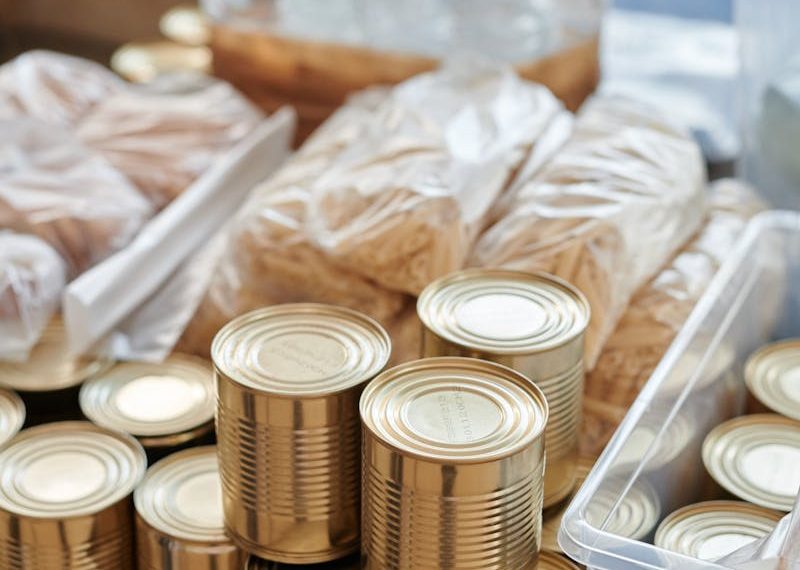 A variety of canned goods and packaged items arranged for a donation drive or food bank collection.