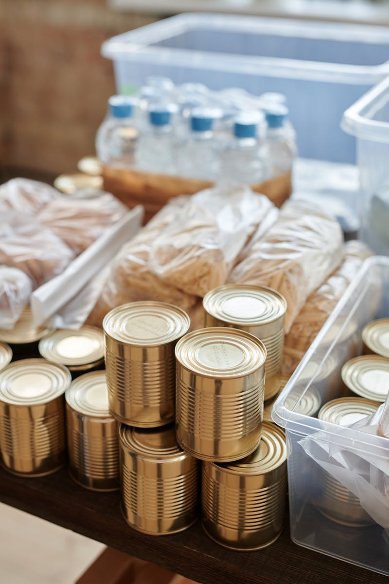 A variety of canned goods and packaged items arranged for a donation drive or food bank collection.