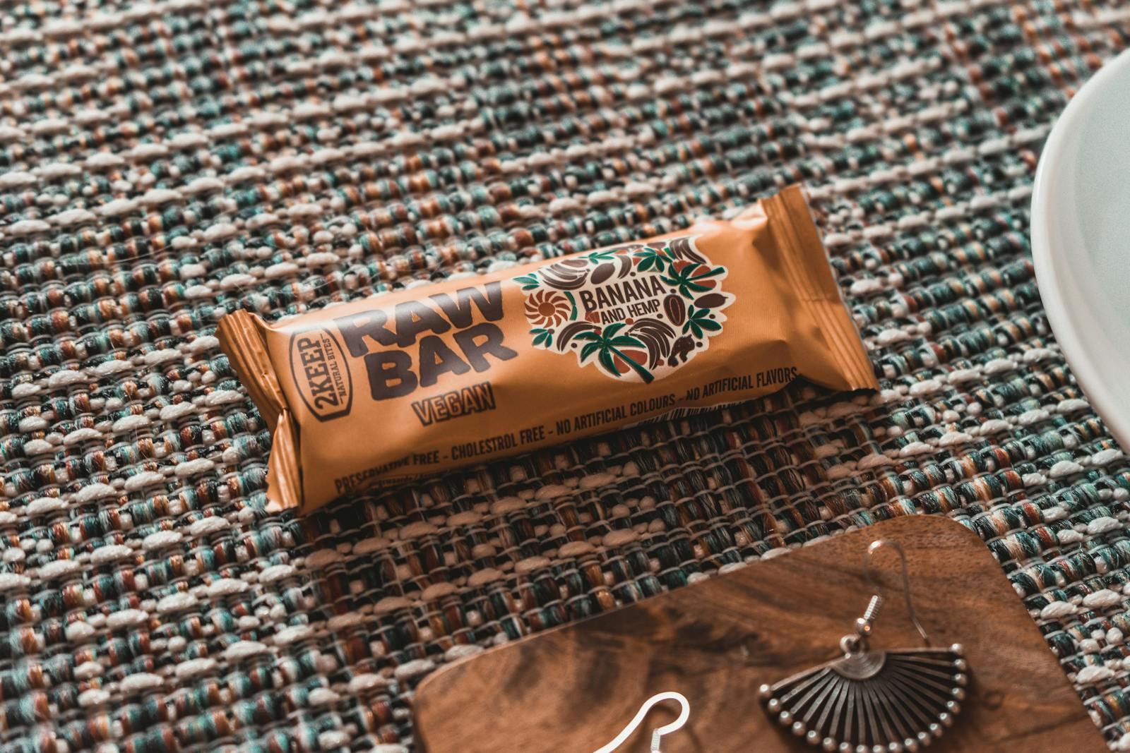 Banana and hemp flavor raw vegan bar on decorative table. Ideal healthy snack.