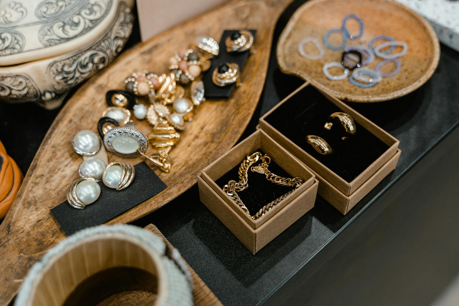 A sophisticated display of assorted jewelry pieces arranged on elegant wooden trays.