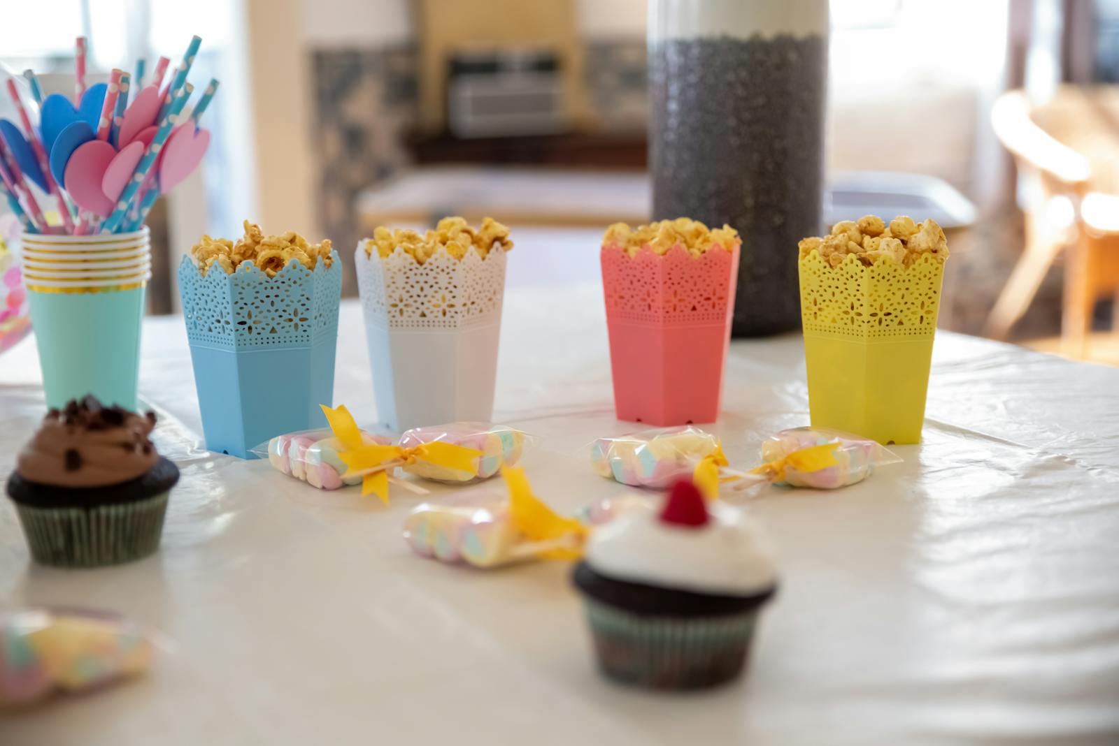 A vibrant table setup with popcorn and cupcakes, ideal for celebrations and parties.