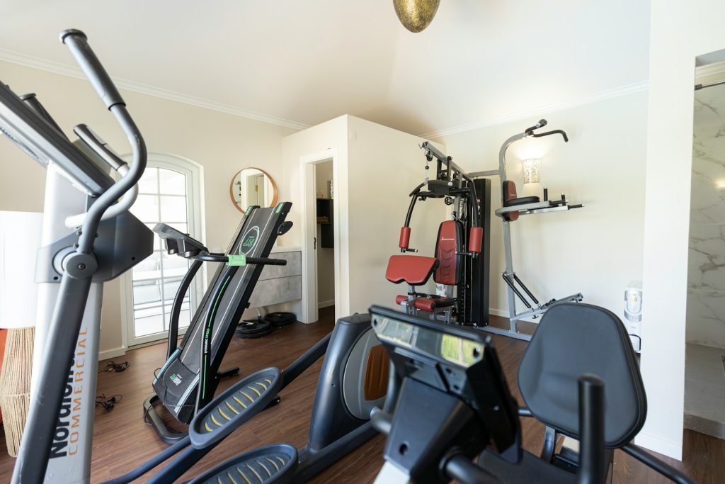 A home gym is equipped with fitness machines.