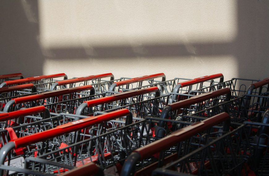 A row of red and silver shopping carts