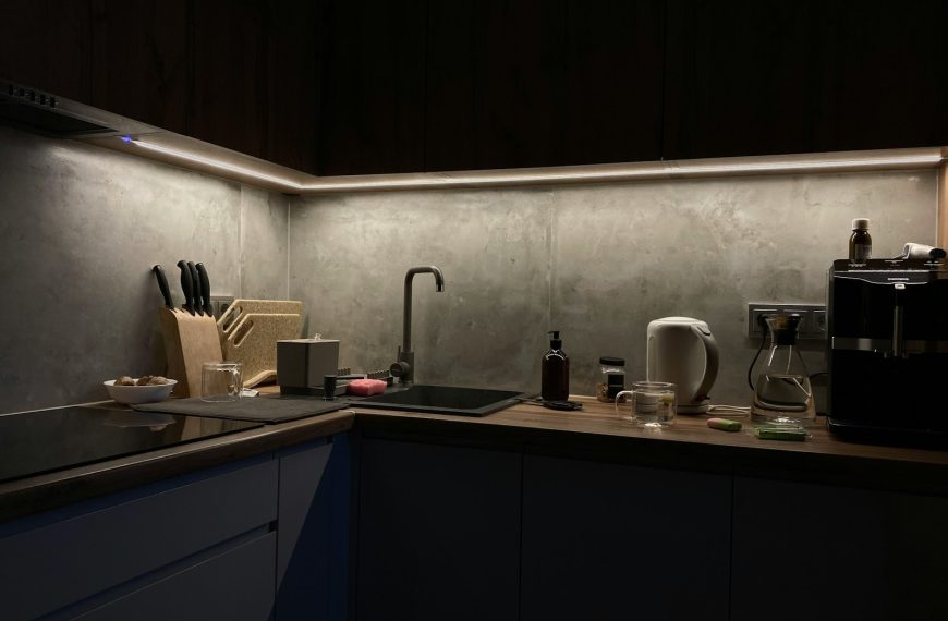 A dimly lit kitchen with a sink and counter