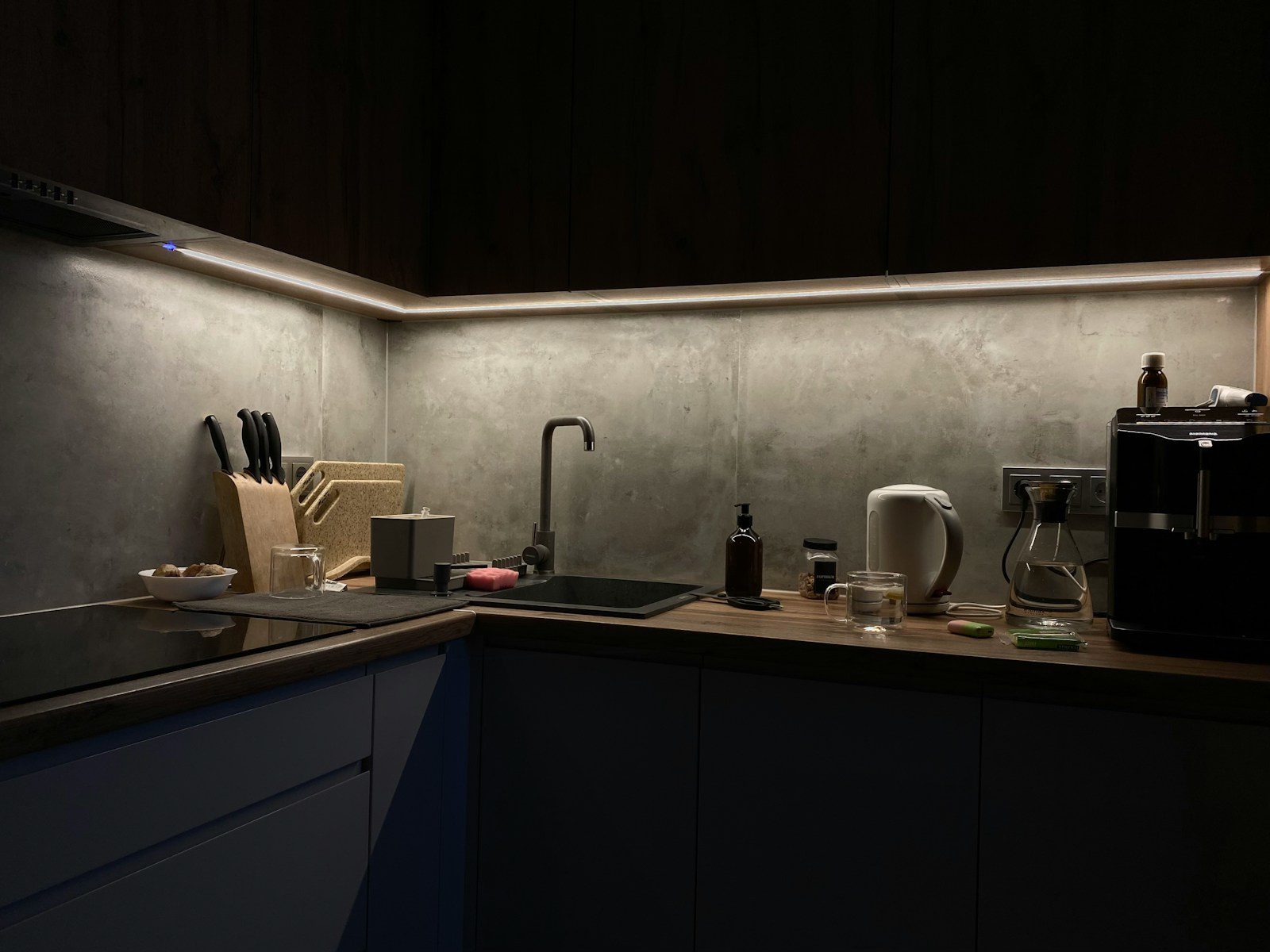 A dimly lit kitchen with a sink and counter