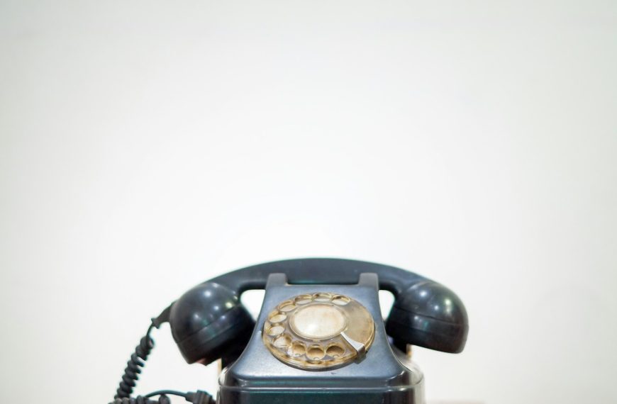black rotary phone on white table