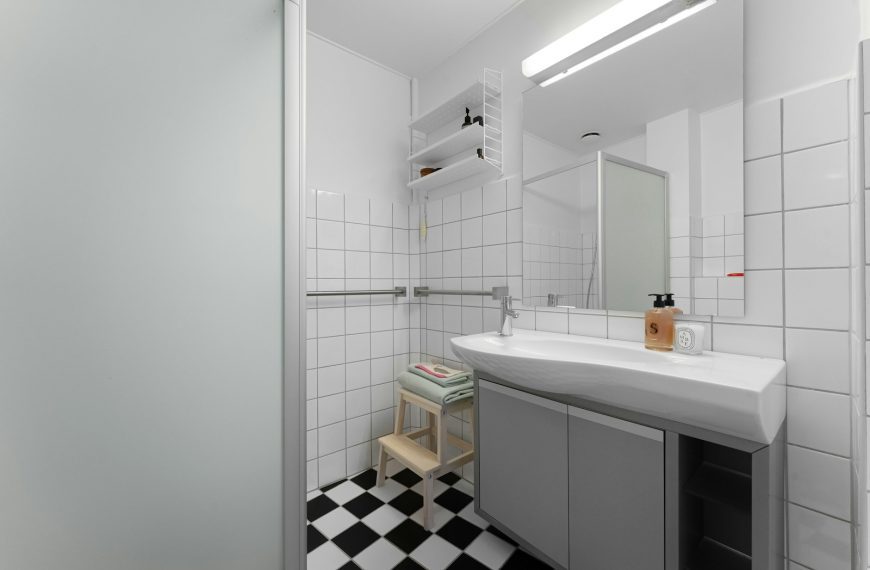 A bathroom with a checkered floor and white walls