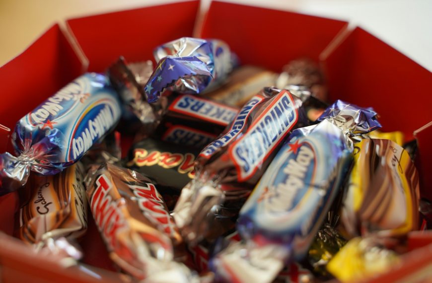 assorted chocolate bar on red shelf