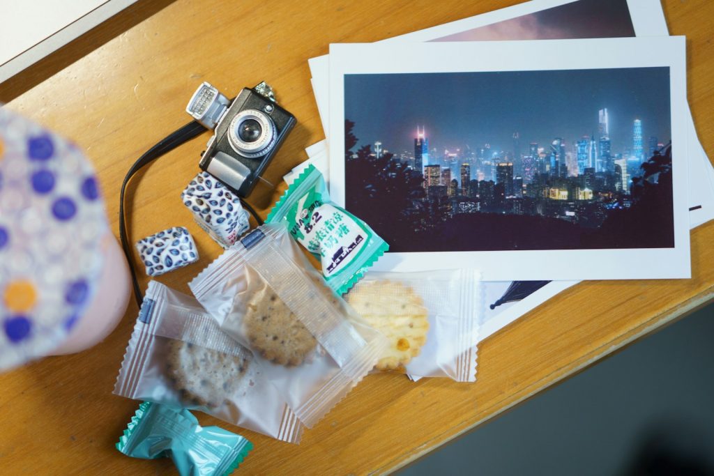 a table with a camera, cookies, and pictures on it