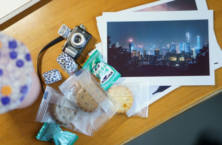 a table with a camera, cookies, and pictures on it