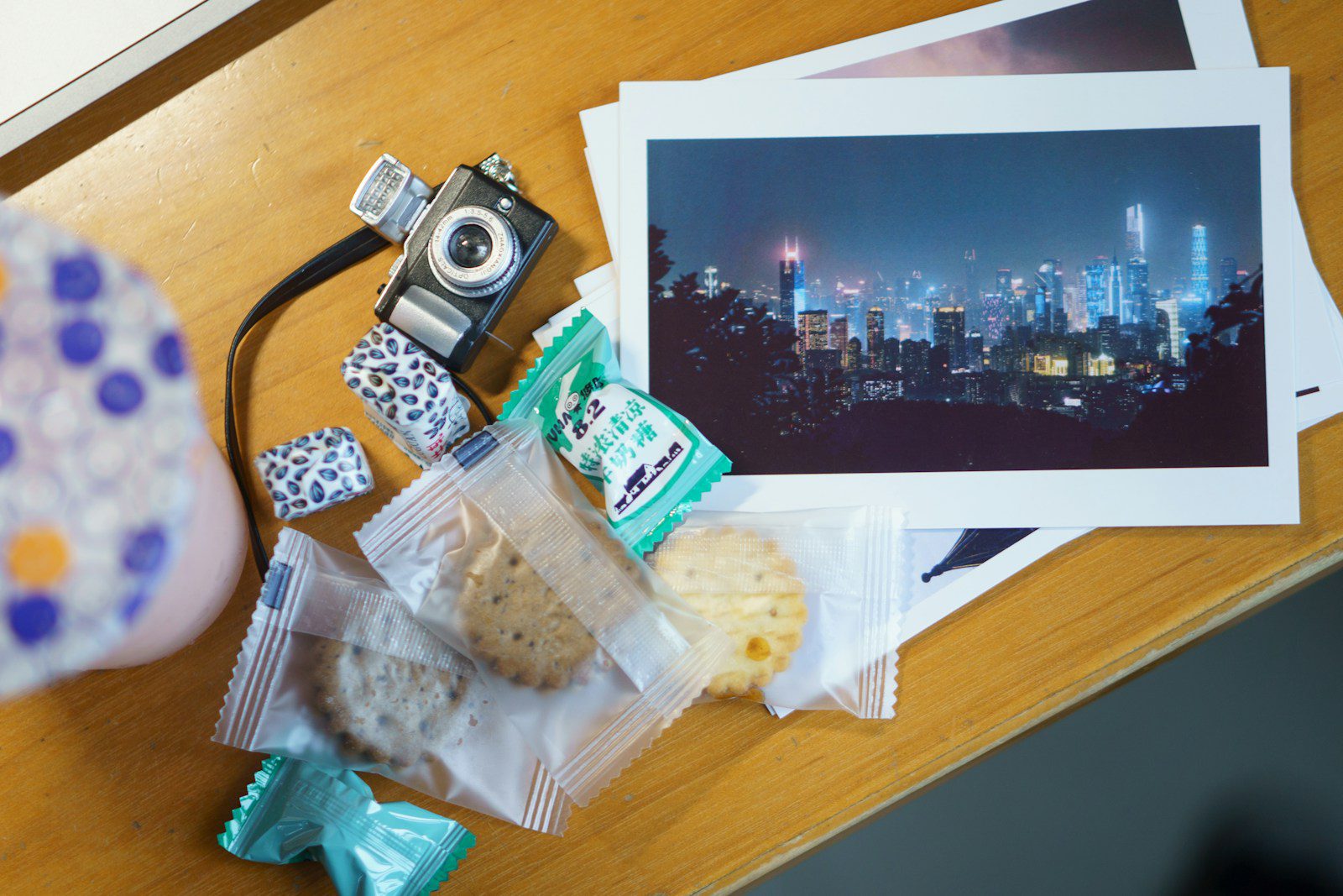 a table with a camera, cookies, and pictures on it