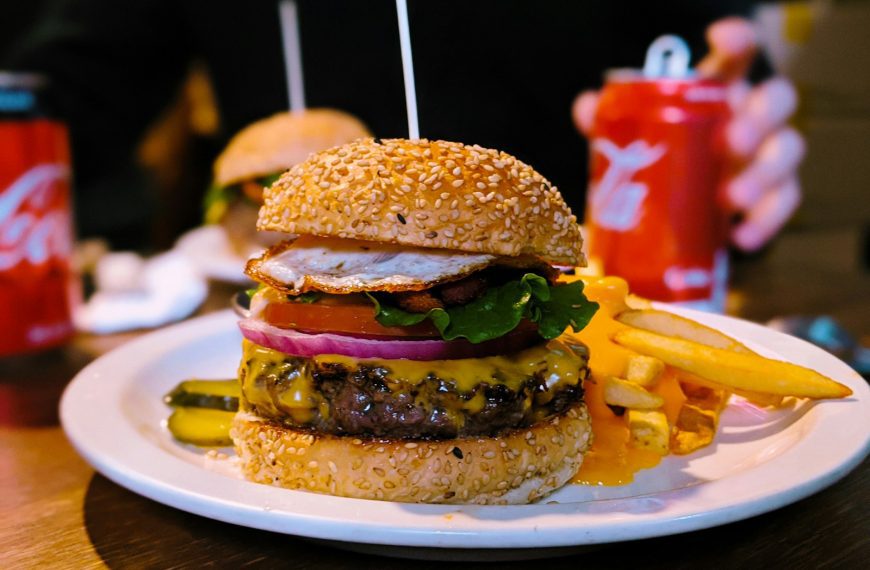 burger with lettuce and tomato on white ceramic plate