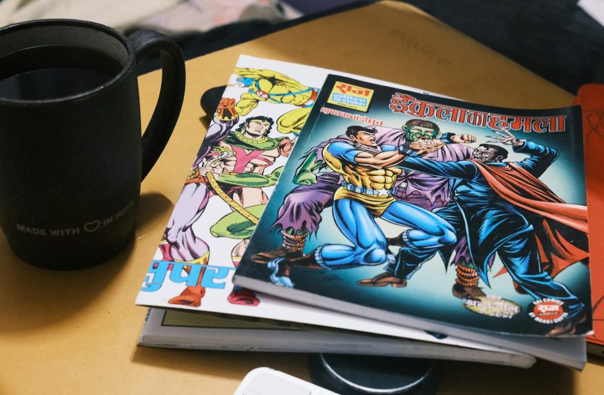 Stack of comic books next to a mug of coffee.