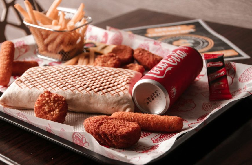 red and white coca cola can beside brown bread on white ceramic plate