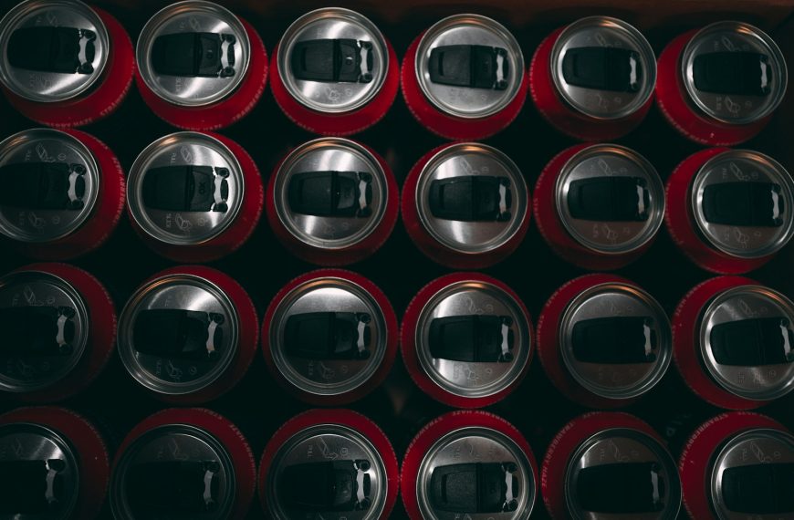 a bunch of soda cans stacked on top of each other