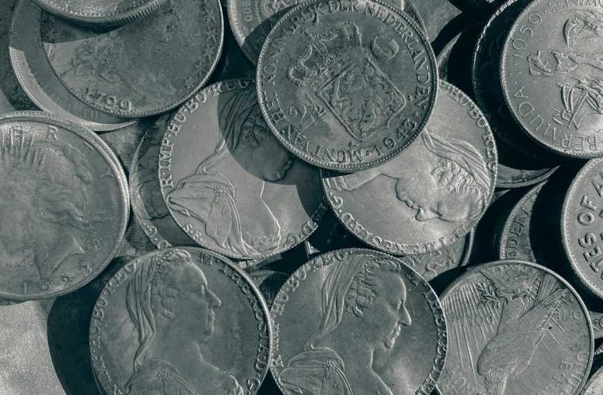 a pile of silver coins sitting on top of a table