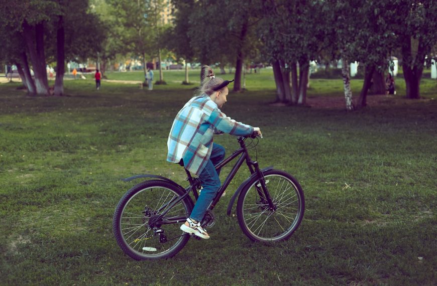 a man riding a bike in a park