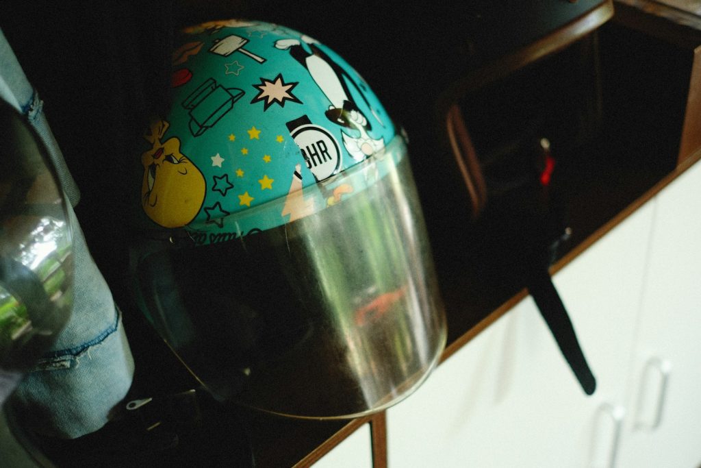 a helmet sitting on top of a counter next to a bottle
