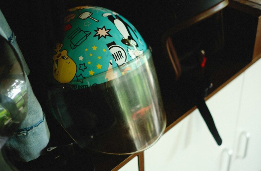 a helmet sitting on top of a counter next to a bottle