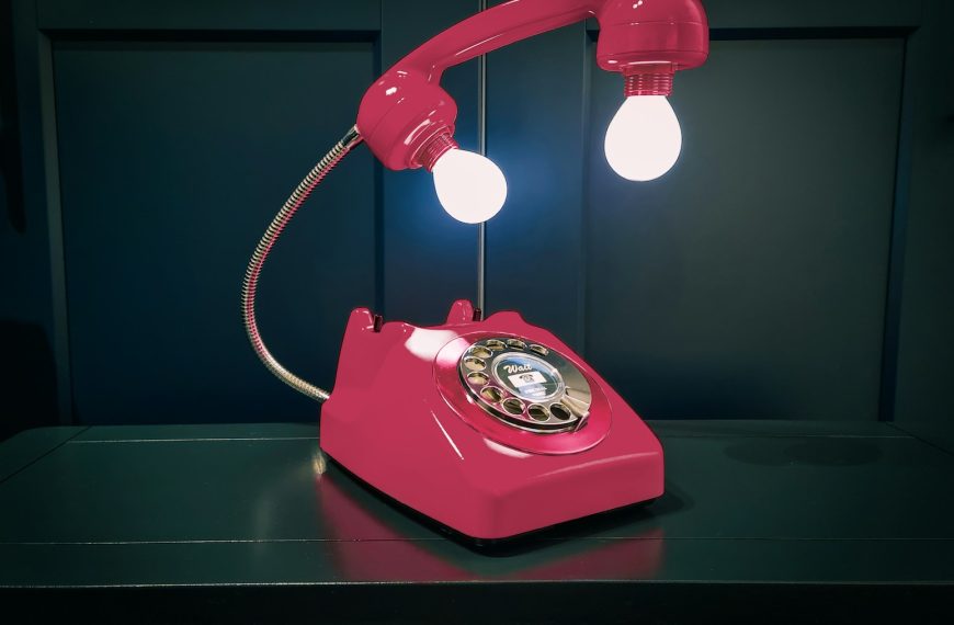 a red telephone sitting on top of a table