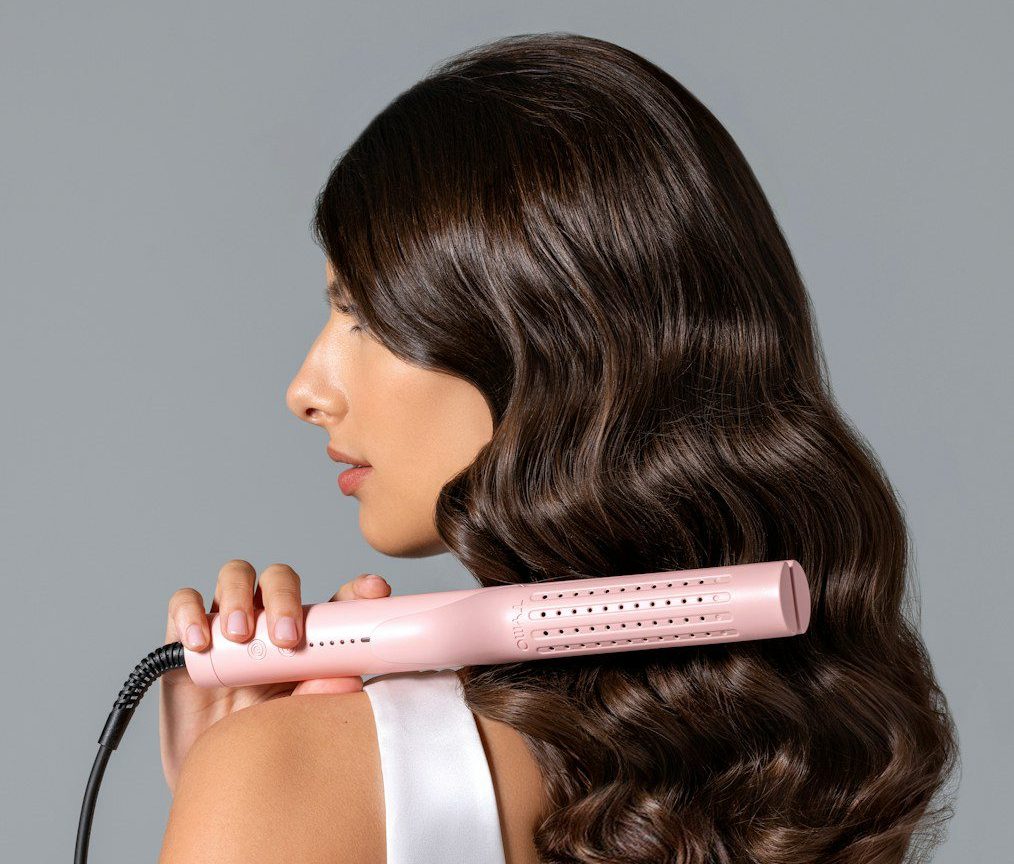 a woman using a hair dryer on her back