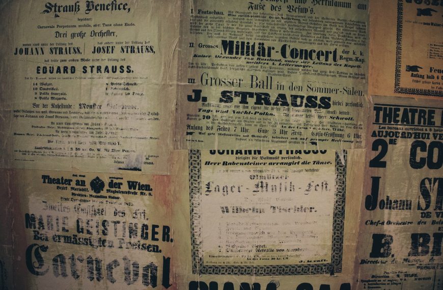 a wall covered in old newspaper with writing on it