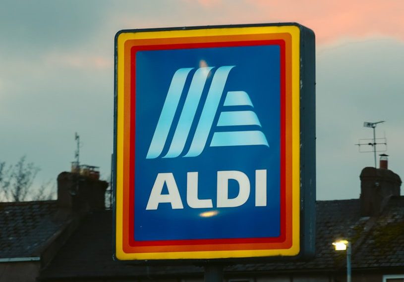 a blue and yellow aldi sign in front of a building