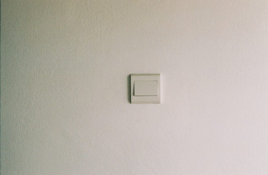 white light switch on white painted wall
