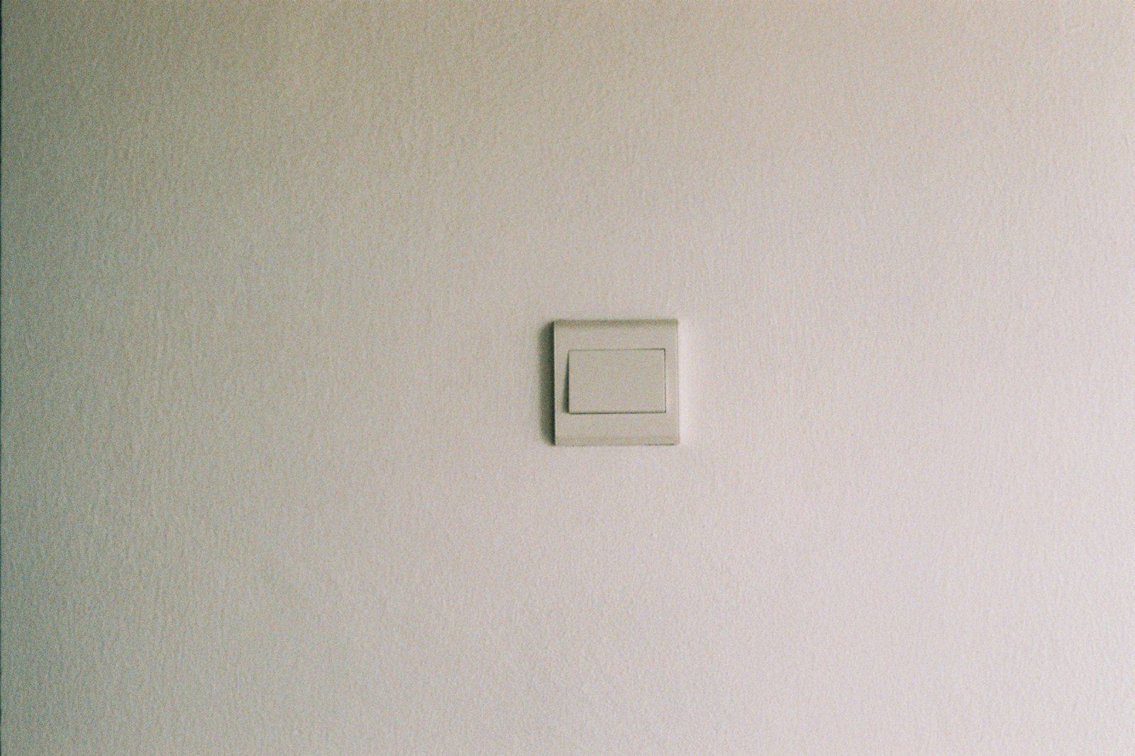 white light switch on white painted wall