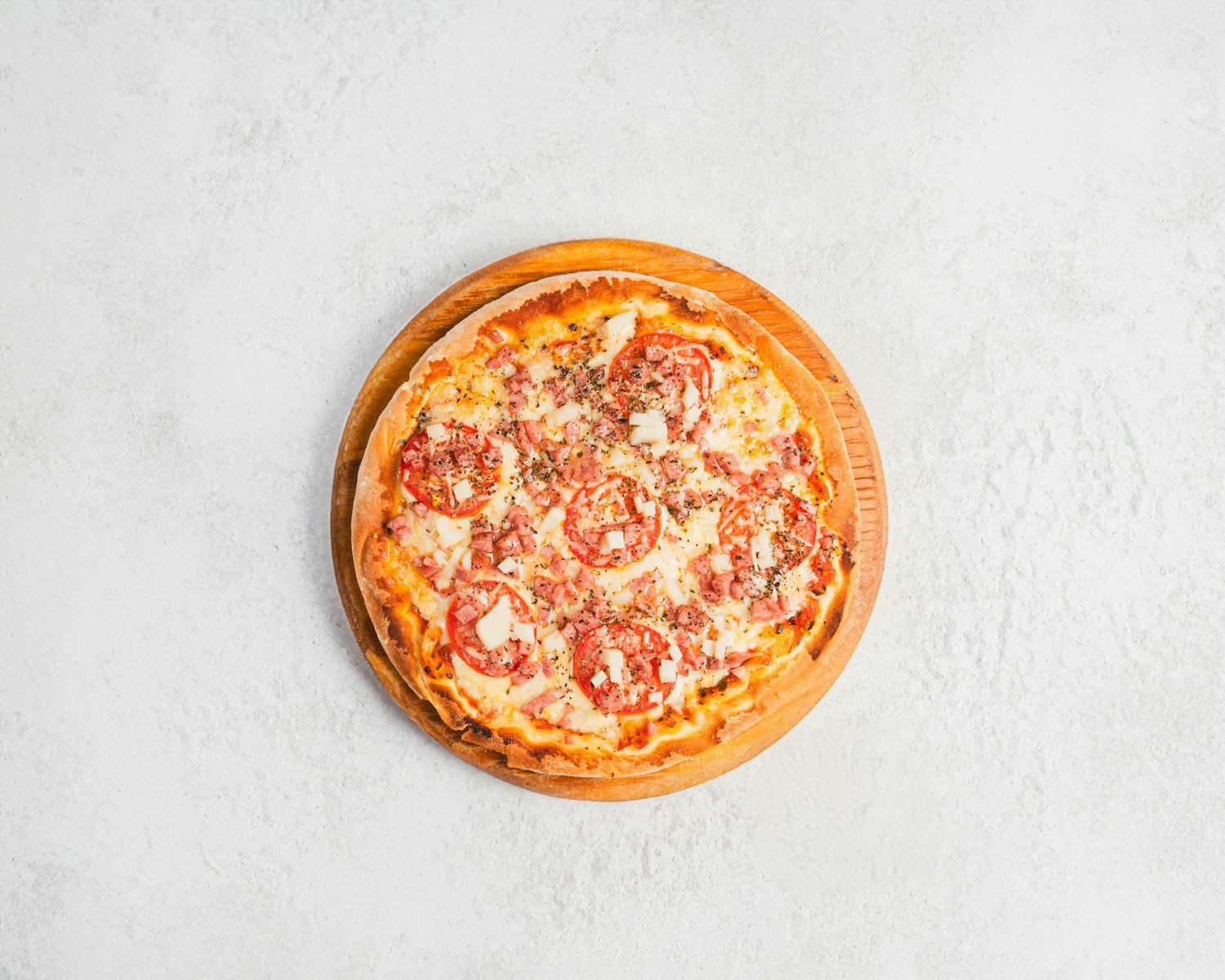 A small pizza sitting on top of a white table
