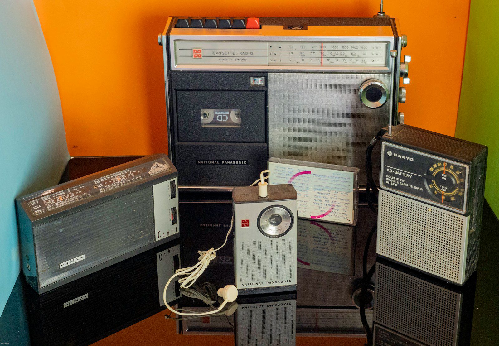 a bunch of old radio's sitting on a table
