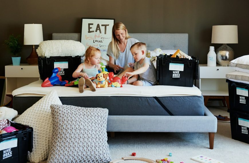 3 children sitting on gray couch