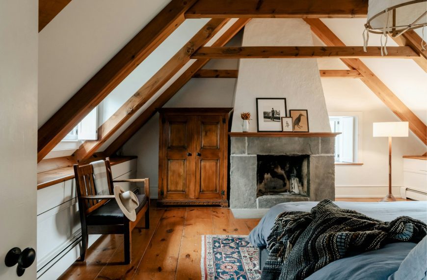 A bedroom with a bed and a fireplace in it