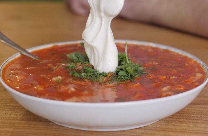 a bowl of soup with sour cream on top