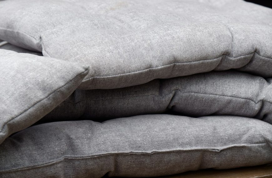 a pile of pillows sitting on top of a wooden table